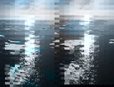 Greenland ice sheets, the sun is gleaming down on them